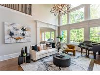 Bright living room features high ceilings, fireplace, and many windows at 2761 Major Ridge Trl, Duluth, GA 30097