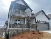 Two-story home with gray siding, stone accents, and a two-car garage at 366 Boundless Ln, Canton, GA 30114