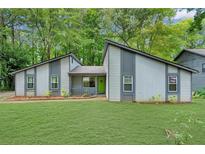 Charming single-story home featuring a well-manicured lawn and unique architectural design at 626 Dover St, Marietta, GA 30066