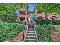 Brick building with staircase, balconies, and lush landscaping at 795 Ponce De Leon Ne Pl # C3, Atlanta, GA 30306