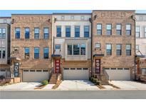 Charming brick townhomes feature attached garages and red front doors, offering modern urban living at 1017 Brandsford Nw St, Atlanta, GA 30318