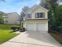 Charming two-story home featuring a two-car garage and manicured landscaping at 3227 Diamond Blf, Union City, GA 30291