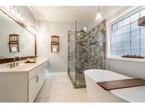 Elegant bathroom with double vanity, large shower, and soaking tub at 7655 Abbey Glen Dr, Cumming, GA 30028