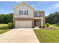 Charming two-story home with a well-manicured lawn and a two-car garage at 55 Cherohala Ct, Covington, GA 30016