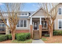 Charming townhome with a welcoming front porch and well-maintained landscaping at 905 Freedom Ln, Roswell, GA 30075