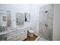 Modern bathroom with double vanity, marble countertops, and a large walk-in shower at 1466 Hardin Ave, Atlanta, GA 30337
