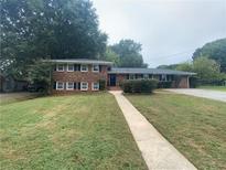 Charming two-story home featuring a well-maintained lawn and a welcoming walkway to the front door at 741 Prince Ave, Marietta, GA 30062