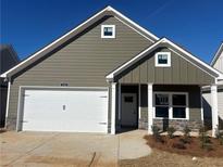 Charming single-story home with a two-car garage, complemented by stone accents and neat landscaping at 124 Sunflower Ne Cir, Cartersville, GA 30121