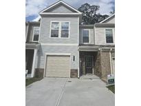 Charming two-story townhouse featuring a one-car garage and a welcoming entrance at 6206 Ripple Way # 89, South Fulton, GA 30349