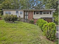 Charming single-story home featuring a brick accent, complemented by mature landscaping for added curb appeal at 2497 Mobley Se Ct, Atlanta, GA 30315