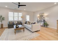 Bright living room featuring a ceiling fan, comfortable seating and lots of natural light from the large window at 1899 Deco Dr, Kennesaw, GA 30144