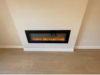 Contemporary fireplace with a sleek black frame adds warmth and style to the living space at 1995 Deco Dr, Kennesaw, GA 30144
