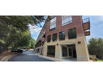 Brick building exterior with parking and landscaping at 319 Atlanta Se St # 317, Marietta, GA 30060