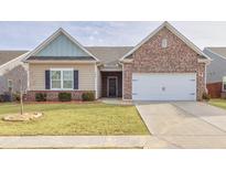 Charming one-story home featuring brick and siding exterior, manicured lawn and a two car garage at 4444 Kendrick Cir, Loganville, GA 30052