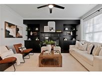 Spacious living room with a fireplace and built-in shelving at 7470 Flintlock Way, Alpharetta, GA 30005