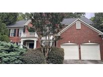 Brick two-story house with two-car garage and landscaping at 2082 Wrights Mill Ne Cir, Brookhaven, GA 30324