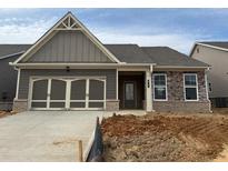 Charming single-story home featuring a two-car garage and mixed material facade at 615 Moorhen Way, Loganville, GA 30052