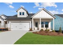 Charming one-story home featuring white siding, a well-manicured lawn, and a two-car garage at 215 Strawberry Ln, Woodstock, GA 30189