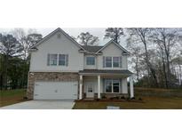 Charming two-story home featuring a brick facade, white siding, and a well-manicured front lawn at 6055 Spring Way, Stonecrest, GA 30038