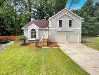 Charming home featuring a two-car garage and well-maintained lawn at 320 Rebecca Lake Way, Fairburn, GA 30213