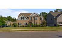 Brick two-story house with gray accents and a manicured lawn at 1995 Woodmont Dr, Douglasville, GA 30135