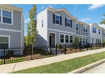 Charming gray two-story home with black shutters, black iron fence, and manicured lawn at 2688 Toucan Way, Atlanta, GA 30331