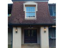 Close up view of the front entrance featuring a dark wooden double door and classic lantern style sconces at 3014 Parc Lorraine Cir # 3014, Lithonia, GA 30038