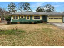 Charming single-story home featuring a well-manicured lawn and a convenient attached garage at 9206 Carlton Nw Trl, Covington, GA 30014