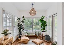 Sunroom with hardwood floors, large windows, and comfortable seating at 50 Biscayne Nw Dr # 3110, Atlanta, GA 30309