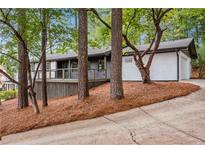 Charming home with a painted brick foundation, nice landscaping, and covered front porch at 2228 Old Dallas Sw Rd, Marietta, GA 30064