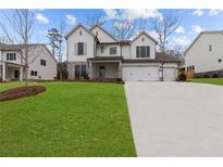 Beautiful two-story home with a three car garage, attractive stone accents and a large manicured lawn at 2364 Ellis Mountain Dr, Marietta, GA 30064