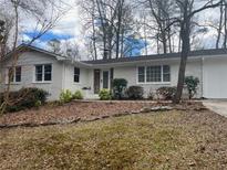 Charming single-story home boasts a freshly painted white exterior and a well-maintained front yard at 246 Plantation Sw Rd, Smyrna, GA 30082