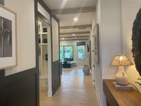 Bright hallway features hardwood floors, decorative lighting, and access to the living room at 250 Mooney Rd, Woodstock, GA 30188