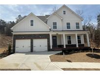 Charming two-story home features a two-car garage, covered porch, and beautiful stone accents at 337 Willow Cv, Canton, GA 30114