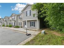 Traditional style gray townhouse with black shutters, covered porch and basketball hoop at 4001 Avalon Sw Rd, Atlanta, GA 30331