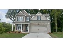 Charming two-story home with brick facade, inviting entrance, attached garage, and well-manicured lawn at 6025 Spring Way, Stonecrest, GA 30038