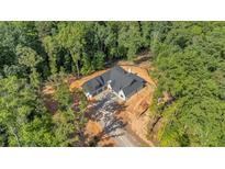 Stunning aerial view of the modern farmhouse-style home nestled in a lush, wooded lot at 107 Marks Way, Canton, GA 30115