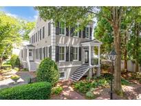 Stunning two-story home featuring black shutters, a brick walkway, and lush landscaping at 3848 Saint Annes Ct, Duluth, GA 30096