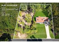 Aerial view of 1.05 acre lot with house and driveway at 4125 Oakwood Trl, Cumming, GA 30040