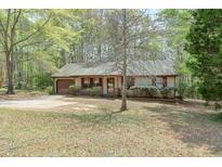Charming single-story home with a driveway, neutral siding, and a well-maintained front yard at 798 Tommy Lee Cook Rd, Palmetto, GA 30268