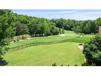 Spacious, well-maintained backyard with lush grass, black fencing, and scenic golf course views at 8150 Albritton Downs, Cumming, GA 30041