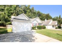 House exterior featuring a two-car garage and well-maintained lawn at 159 Misty Ridge Trl, Stockbridge, GA 30281