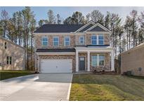 Charming two-story brick home with a two-car garage and well-maintained front yard at 125 Belvedere Rd, Mcdonough, GA 30253