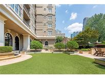 Beautiful condo courtyard with verdant landscaping and sitting areas at 3334 Peachtree Ne Rd # 514, Atlanta, GA 30326