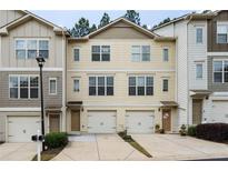 Charming townhome featuring an attached garage, neutral siding, and well maintained landscaping at 1801 Liberty Nw Pkwy, Atlanta, GA 30318