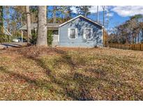 Ranch style home with blue siding, covered porch and a spacious yard at 1367 Fairview Trl, Lawrenceville, GA 30043