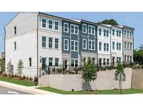 Beautiful exterior of new townhomes with brick foundations and professionally landscaped front yards at 373 Skylar Se Way, Atlanta, GA 30315