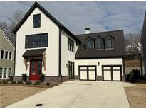 Beautiful two-story home featuring white siding, black trim, a red front door, and a spacious driveway at 7275 Cordery Rd, Cumming, GA 30040
