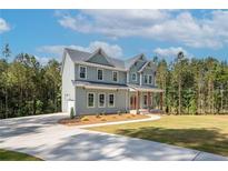 Charming two-story home with a manicured lawn and a long concrete driveway at 1702 Eastside Parc St, Atlanta, GA 30316
