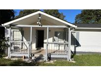 Quaint home featuring a covered front porch with gray railing, offering a welcoming entrance at 698 Rocky Plains Rd, Covington, GA 30016